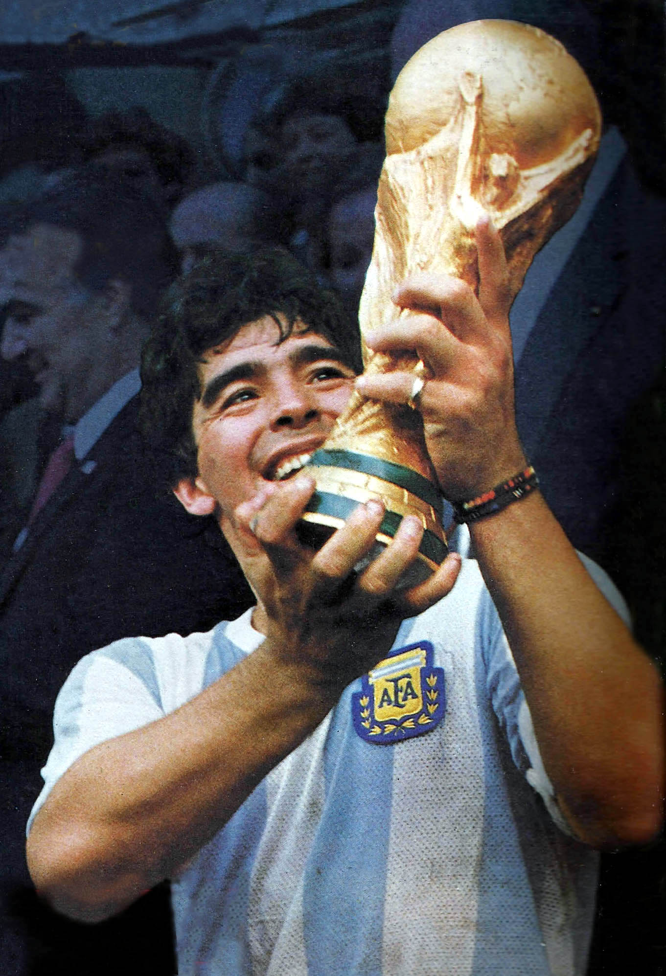 Diego Maradona lifts the World Cup trophy in the Argentina 1986 sky-blue and white home shirt at the Estadio Azteca