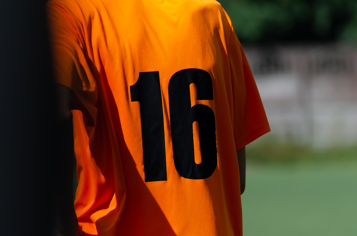 Close-up of a football shirt back showing the printed squad number 16