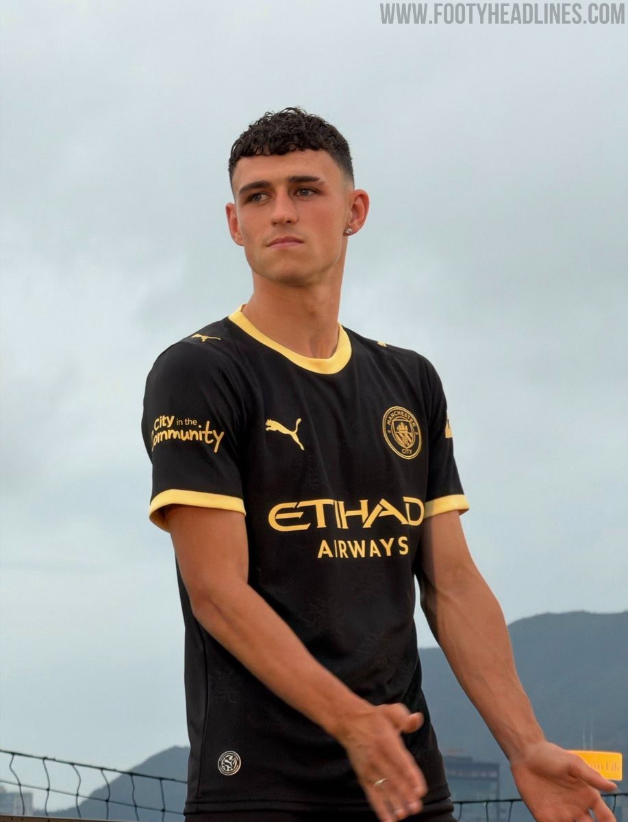 Manchester City 2026-27 Puma away kit in black with yellow and gold trim, unveiled in Hong Kong